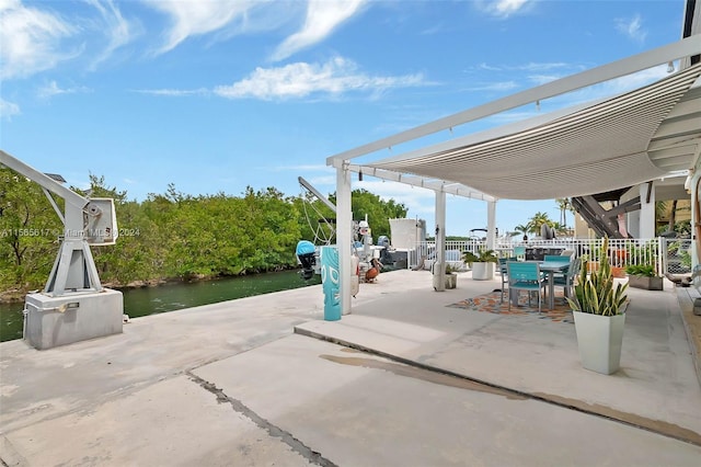 view of patio / terrace featuring a pergola and a water view