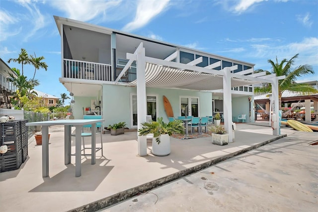 back of house featuring a patio area, a bar, and a pergola