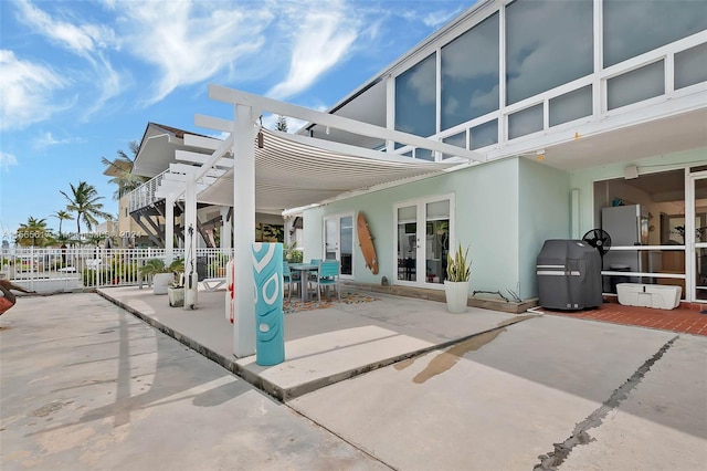 view of patio with french doors and a pergola