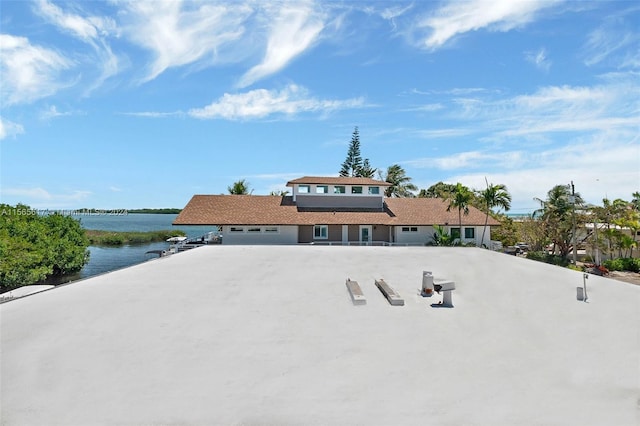 view of front of house with a water view