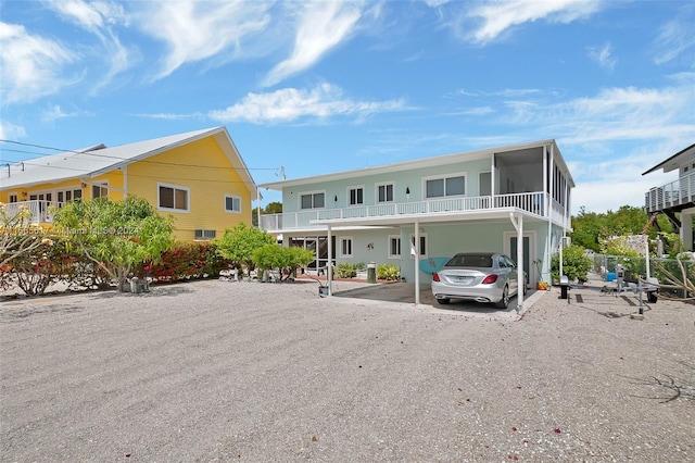 rear view of property with a carport