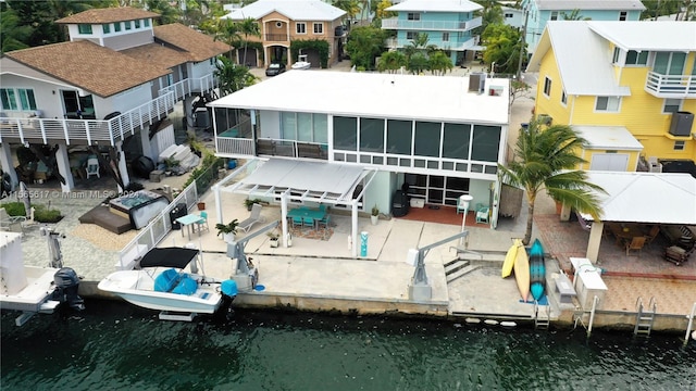 back of house featuring a patio area, a water view, and a balcony