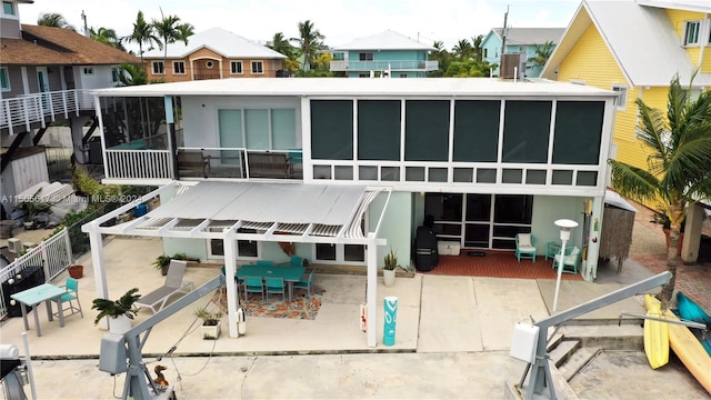 back of property featuring a patio and a sunroom