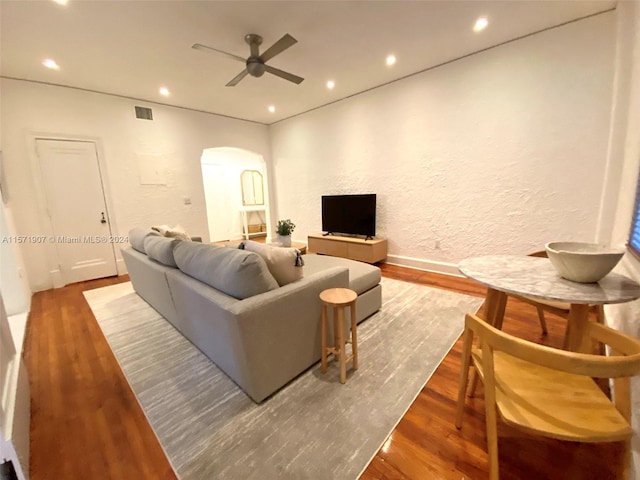 living room featuring wood-type flooring and ceiling fan