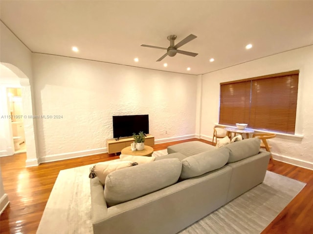 living room featuring wood-type flooring and ceiling fan