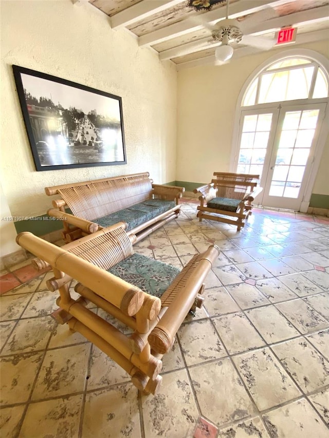 unfurnished living room with beam ceiling, tile floors, and french doors