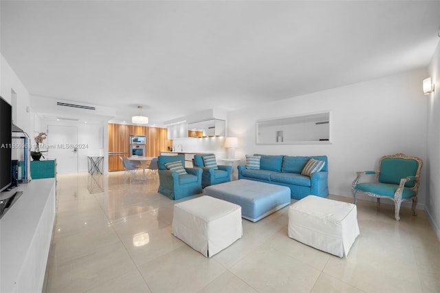 living room with sink and light tile floors