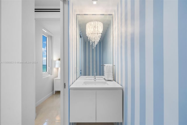 bathroom featuring a chandelier, vanity, and tile floors