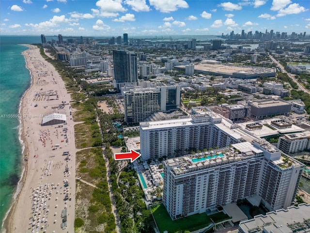 birds eye view of property with a water view and a view of the beach