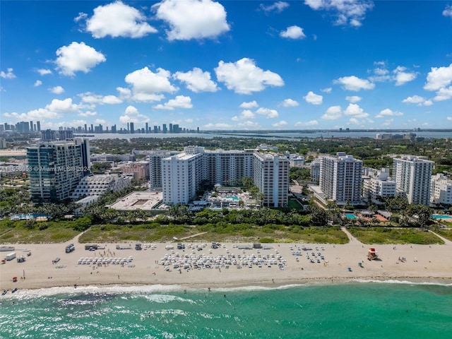 drone / aerial view featuring a beach view and a water view