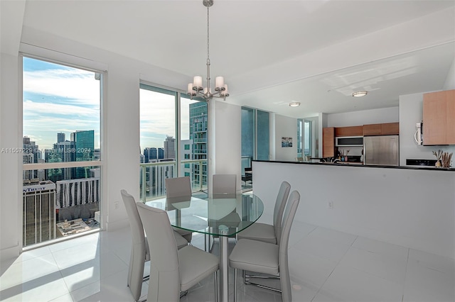 dining area featuring a chandelier and light tile floors