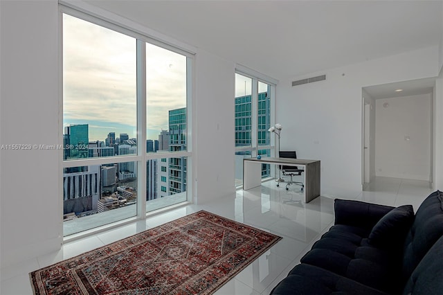 tiled living room with floor to ceiling windows