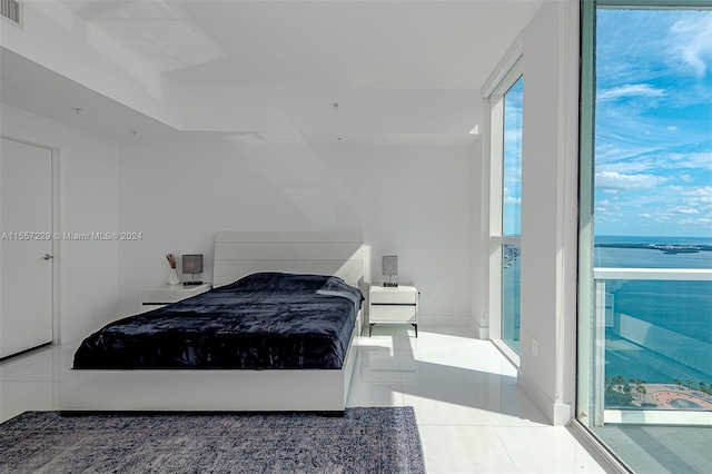 tiled bedroom with a water view