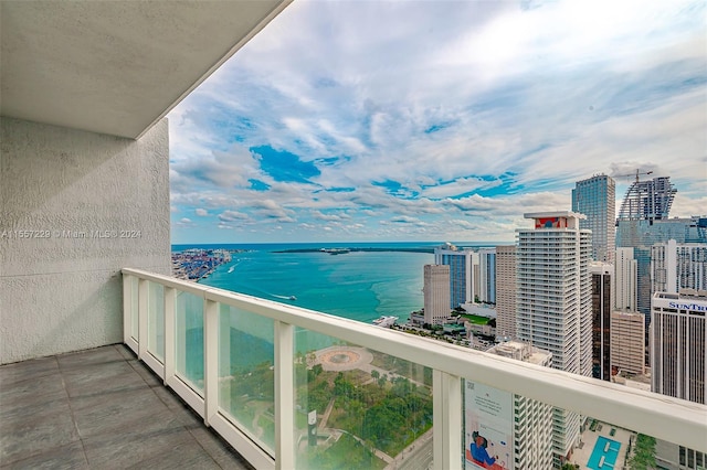 balcony with a water view and central air condition unit