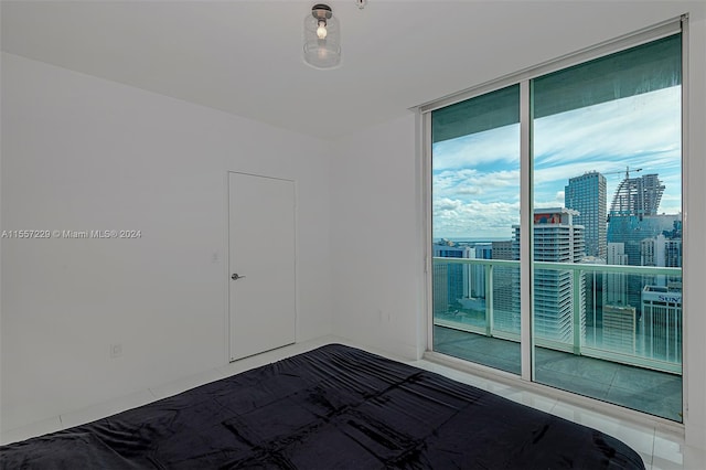 unfurnished bedroom with dark tile flooring