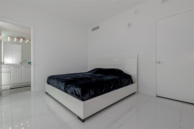 bedroom with light tile flooring