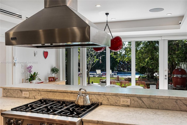 kitchen featuring range and island range hood