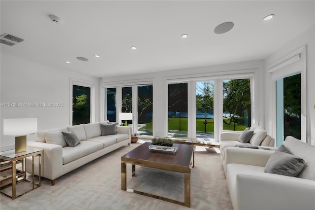 living room with french doors and light colored carpet