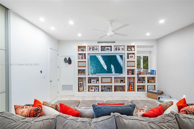 living room featuring ceiling fan and hardwood / wood-style floors