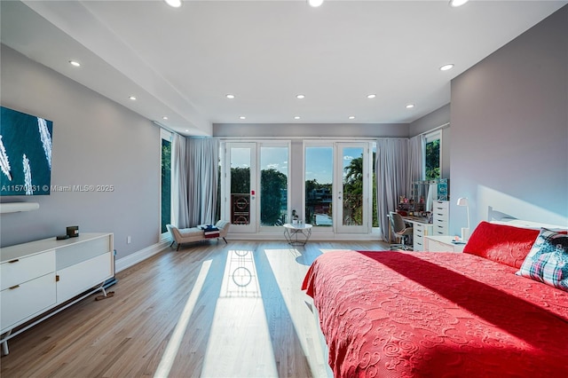 bedroom featuring light wood-type flooring and french doors