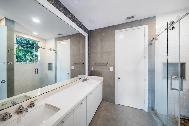 bathroom with vanity, an enclosed shower, and concrete flooring