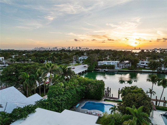 aerial view at dusk with a water view