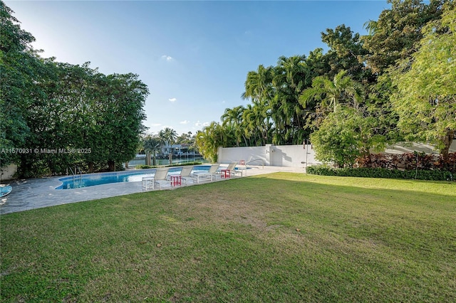 view of yard featuring a patio area and a fenced in pool