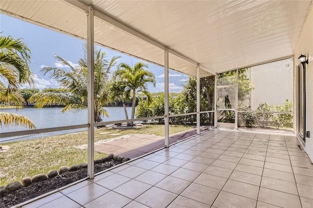 unfurnished sunroom featuring a water view