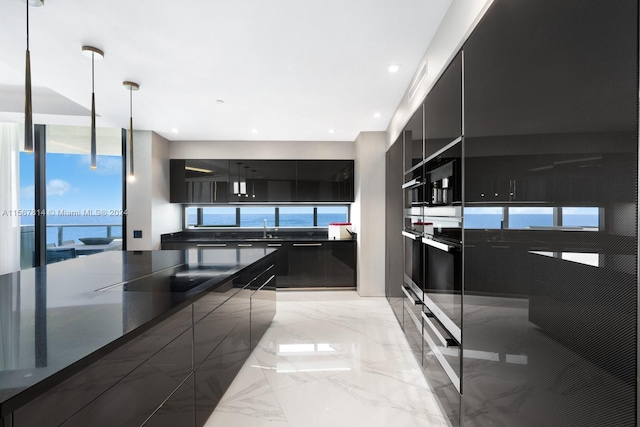 kitchen featuring wall oven, pendant lighting, sink, and light tile flooring