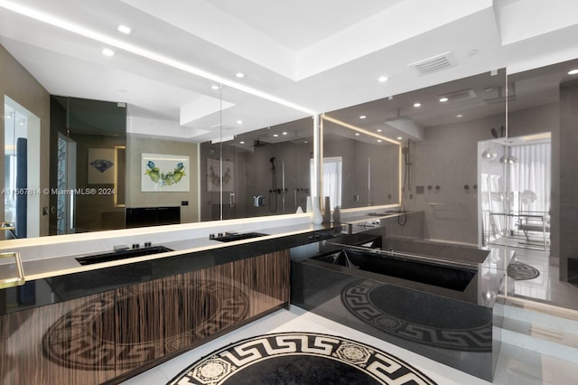 bathroom featuring vanity with extensive cabinet space, tile flooring, and a raised ceiling