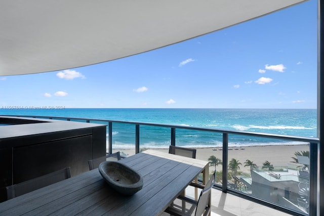 balcony featuring a water view and a view of the beach