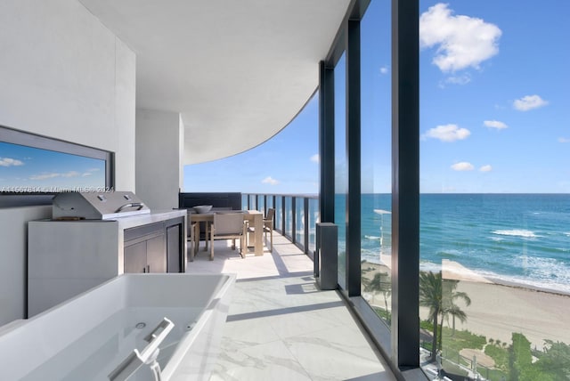 balcony with a beach view and a water view