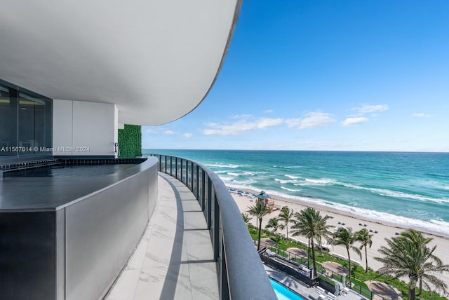 balcony with a water view and a beach view