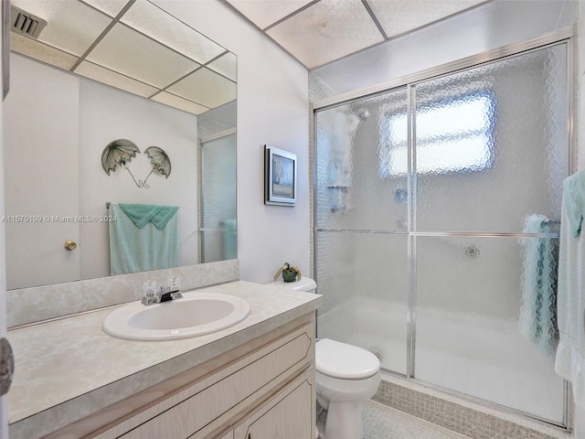 bathroom with an enclosed shower, toilet, tile floors, and vanity