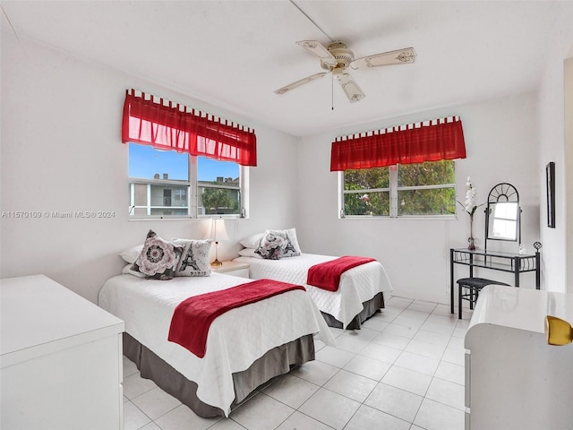 bedroom featuring multiple windows, ceiling fan, and light tile floors