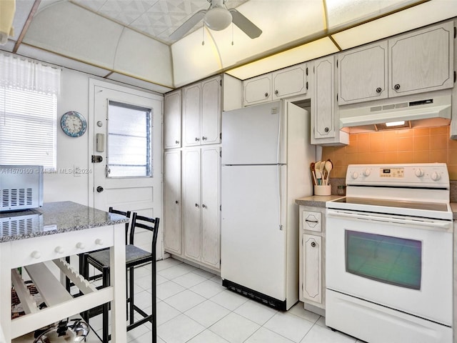 kitchen featuring white appliances, light tile flooring, and ceiling fan