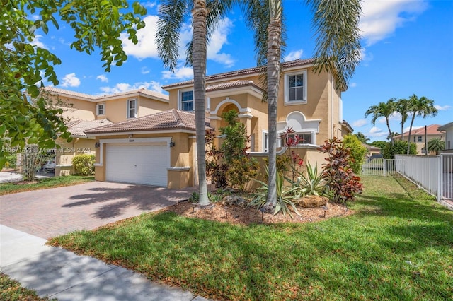 mediterranean / spanish house featuring a front lawn and a garage