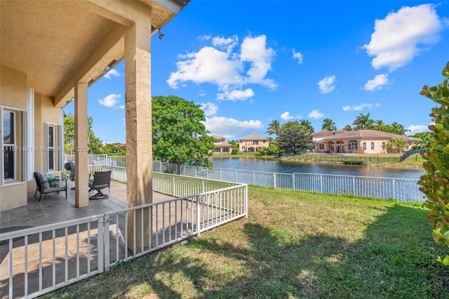 view of yard featuring a patio area and a water view