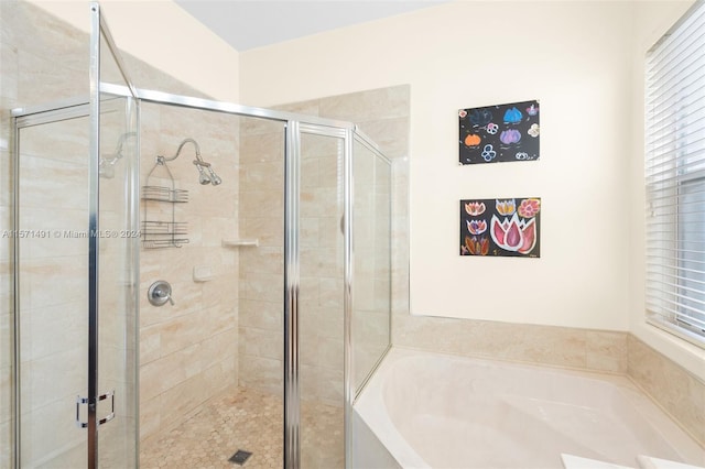 bathroom featuring separate shower and tub