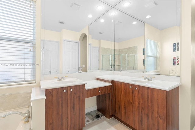 bathroom featuring shower with separate bathtub, vanity, and tile patterned flooring