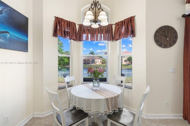 dining room with a chandelier and light tile patterned floors