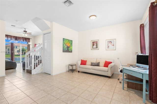 tiled living room featuring ceiling fan