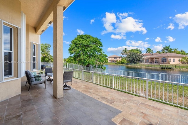 view of patio with a water view