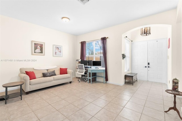 living room featuring a chandelier and light tile patterned floors