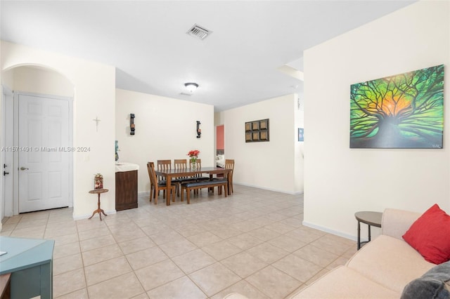 dining space featuring light tile patterned flooring