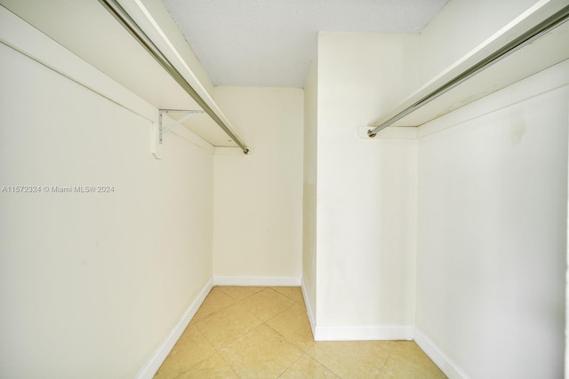 spacious closet featuring light tile floors