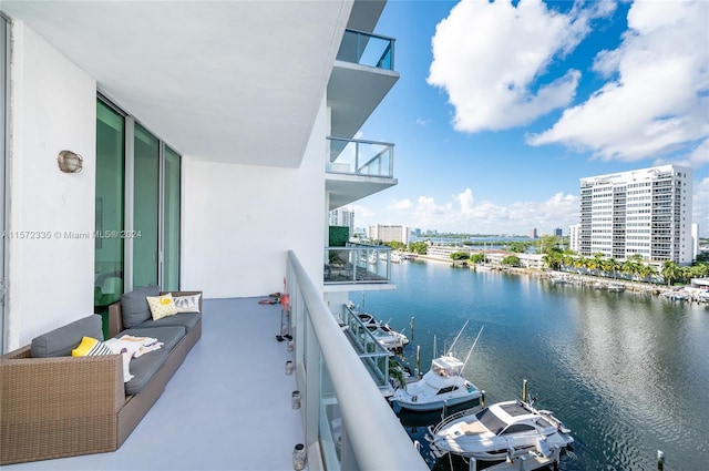 balcony with a water view and an outdoor living space