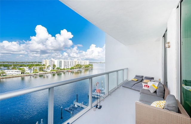 balcony featuring an outdoor living space and a water view