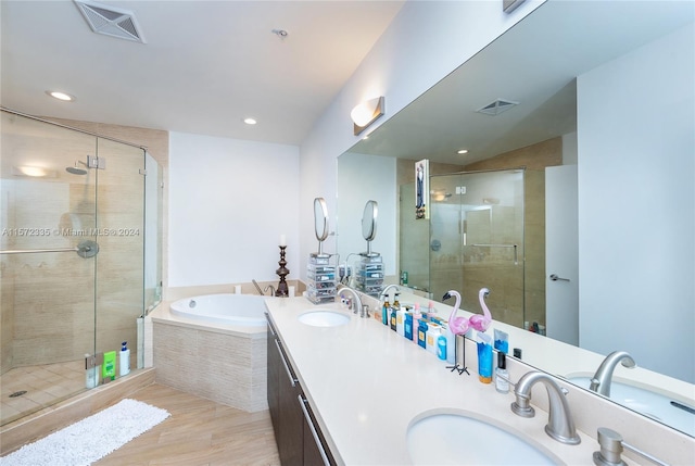 bathroom with independent shower and bath and dual vanity