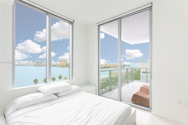 tiled bedroom with a water view